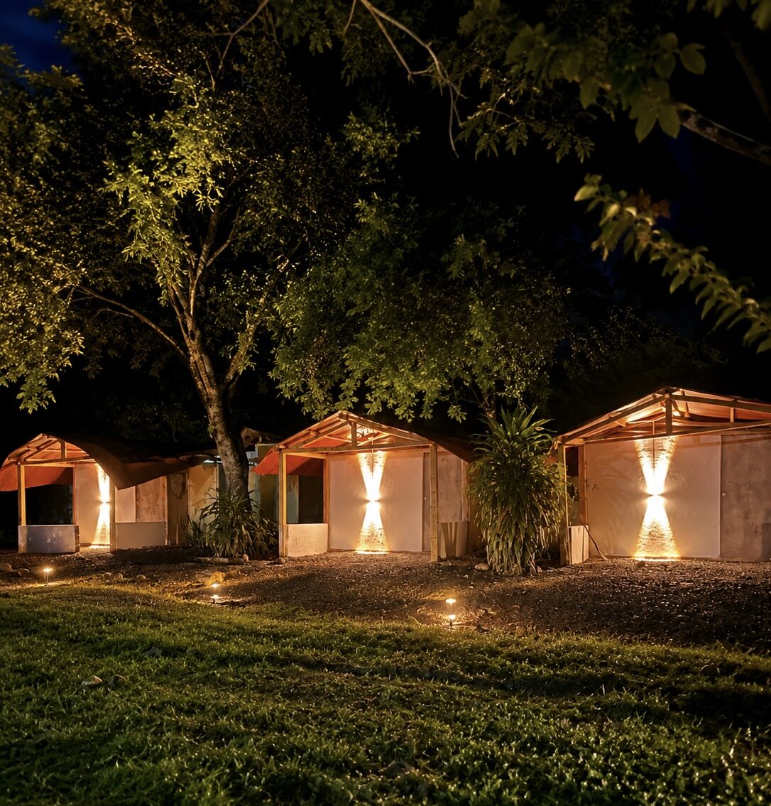 Los tres glampings independientes iluminados entre los árboles